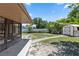 A serene backyard with a shed and lush trees beyond the white fence at 1299 Buccaneer Ave, Deltona, FL 32725