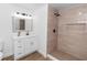 Modern bathroom with a tiled shower, sleek vanity, and stylish mirror for a luxurious feel at 1299 Buccaneer Ave, Deltona, FL 32725