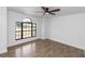 Comfortable bedroom with wood-look flooring and a large window that allows natural lighting at 1299 Buccaneer Ave, Deltona, FL 32725
