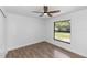 Clean bedroom with modern ceiling fan, closet, and large window offering natural light at 1299 Buccaneer Ave, Deltona, FL 32725