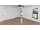 Clean bedroom with tile floors, large windows, and closet storage at 1299 Buccaneer Ave, Deltona, FL 32725