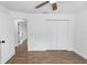 Spacious bedroom with wood-look flooring, closet, and neutral paint, creating a serene atmosphere at 1299 Buccaneer Ave, Deltona, FL 32725