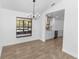 Dining room with tile floor, chandelier, and view into modern updated kitchen at 1299 Buccaneer Ave, Deltona, FL 32725