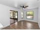 Open living area with windows, sliding glass door, and modern ceiling fan at 1299 Buccaneer Ave, Deltona, FL 32725