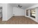 Bright living room featuring tile floors, a modern ceiling fan, and ample sunlight from large windows at 1299 Buccaneer Ave, Deltona, FL 32725
