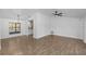 Open-concept living room with stylish tile flooring, modern lighting, and bright natural light at 1299 Buccaneer Ave, Deltona, FL 32725