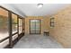 A bright and airy screened porch with brick walls and outdoor access at 1299 Buccaneer Ave, Deltona, FL 32725