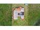 Aerial view of home with a screened-in patio and mature lawn at 13023 Sweet Hill Rd, Polk City, FL 33868