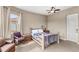 Comfortable bedroom with a unique bed frame, cozy armchair, and natural light at 13023 Sweet Hill Rd, Polk City, FL 33868