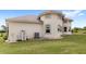 Exterior shot of a home featuring stucco siding, manicured lawn and rounded architectural design at 13023 Sweet Hill Rd, Polk City, FL 33868