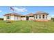 Stunning single-story home with attached garages and lush green lawn at 13023 Sweet Hill Rd, Polk City, FL 33868