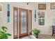 Beautiful front door with decorative glass accents and sidelights at 13023 Sweet Hill Rd, Polk City, FL 33868