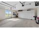 Spacious garage with two-car doors, work area, and a wall of cabinets for lots of storage at 13023 Sweet Hill Rd, Polk City, FL 33868