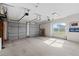 Spacious garage with two-car doors and two automatic openers, with a window to let natural light in at 13023 Sweet Hill Rd, Polk City, FL 33868