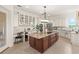 Gourmet kitchen featuring custom cabinets, stainless steel appliances, and a large center island at 13023 Sweet Hill Rd, Polk City, FL 33868