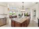 Gourmet kitchen with stone countertops, stainless steel appliances, and eat in area at 13023 Sweet Hill Rd, Polk City, FL 33868