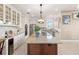 Gourmet kitchen featuring custom cabinets, stainless steel appliances, and a large center island at 13023 Sweet Hill Rd, Polk City, FL 33868