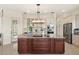 Gourmet kitchen featuring custom cabinets, stainless steel appliances, and a large center island at 13023 Sweet Hill Rd, Polk City, FL 33868