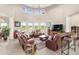 Open-concept living area with large windows and tile floors at 13023 Sweet Hill Rd, Polk City, FL 33868