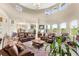 Spacious living room featuring high ceilings, windows, and tile flooring at 13023 Sweet Hill Rd, Polk City, FL 33868