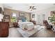 Main bedroom with hardwood floors, natural light, and views of the surrounding landscape at 13023 Sweet Hill Rd, Polk City, FL 33868