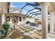 Enclosed patio featuring a dining set with shade umbrella at 13023 Sweet Hill Rd, Polk City, FL 33868