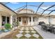 Enclosed patio with outdoor dining and comfortable seating area at 13023 Sweet Hill Rd, Polk City, FL 33868