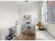 Cozy pet room with feeding station, toys on shelves and in a bowl, wood look flooring, and a sunlit window at 13023 Sweet Hill Rd, Polk City, FL 33868