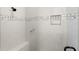 The walk-in shower features elegant marble tiling, a built-in bench, and a convenient shower caddy at 13023 Sweet Hill Rd, Polk City, FL 33868