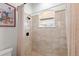 Bright shower with tiled walls, a window, shower curtain, and a framed Mickey Mouse picture hanging on the wall at 13023 Sweet Hill Rd, Polk City, FL 33868