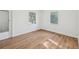 Well-lit bedroom showcasing wood-look floors and dual windows at 1320 E Lombardy Dr, Deltona, FL 32725