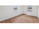 Bedroom with hardwood flooring and multiple windows at 1320 E Lombardy Dr, Deltona, FL 32725