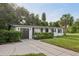 Inviting home showcases manicured hedges, a driveway, and an attached garage, offering both curb appeal and convenience at 1320 E Lombardy Dr, Deltona, FL 32725