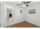 Hallway featuring tile flooring, lighting, access to bedroom and front entry door at 1320 E Lombardy Dr, Deltona, FL 32725