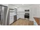 Close-up of the kitchen with stainless steel appliances, light countertops, and modern cabinetry at 1320 E Lombardy Dr, Deltona, FL 32725