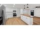 Open-concept kitchen featuring stainless steel appliances and a wood-topped kitchen island at 1320 E Lombardy Dr, Deltona, FL 32725