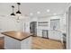 Bright kitchen featuring a wood-topped island, stainless steel appliances, and white cabinets at 1320 E Lombardy Dr, Deltona, FL 32725