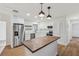The kitchen features stainless steel appliances, an island, and modern pendant lighting at 1320 E Lombardy Dr, Deltona, FL 32725
