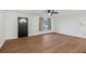 Spacious living room featuring new wood flooring, white walls, and a ceiling fan at 1320 E Lombardy Dr, Deltona, FL 32725