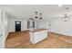 Open-concept living area with a kitchen island, wood floors, and a welcoming entrance at 1320 E Lombardy Dr, Deltona, FL 32725