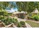 Beautiful backyard featuring a lush garden, stone patio, and mature trees at 1453 Maple Leaf Ln, Deland, FL 32724