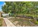 Spacious backyard with lush greenery, a manicured lawn, and a brick-lined walkway at 1453 Maple Leaf Ln, Deland, FL 32724