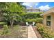 Inviting backyard seating area surrounded by lush greenery and mature landscaping at 1453 Maple Leaf Ln, Deland, FL 32724