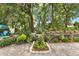 Serene backyard featuring a landscaped garden and a variety of lush plants and trees at 1453 Maple Leaf Ln, Deland, FL 32724