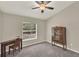 Bedroom with desk, wooden cabinet and a large window overlooking trees at 1453 Maple Leaf Ln, Deland, FL 32724