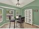 Cozy dining area features a bay window, glass table, and accent lighting fixture at 1453 Maple Leaf Ln, Deland, FL 32724