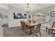 Elegant dining room with a modern chandelier and a large window, perfect for hosting dinner parties at 1453 Maple Leaf Ln, Deland, FL 32724