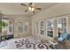 Cozy Florida room with ceiling fan, comfortable seating, and multiple French doors at 1453 Maple Leaf Ln, Deland, FL 32724