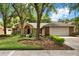 Charming brick home featuring a well-manicured lawn and mature trees, offering great curb appeal at 1453 Maple Leaf Ln, Deland, FL 32724