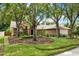 Beautiful brick home with a neatly landscaped front yard and mature trees, offering a welcoming entrance at 1453 Maple Leaf Ln, Deland, FL 32724